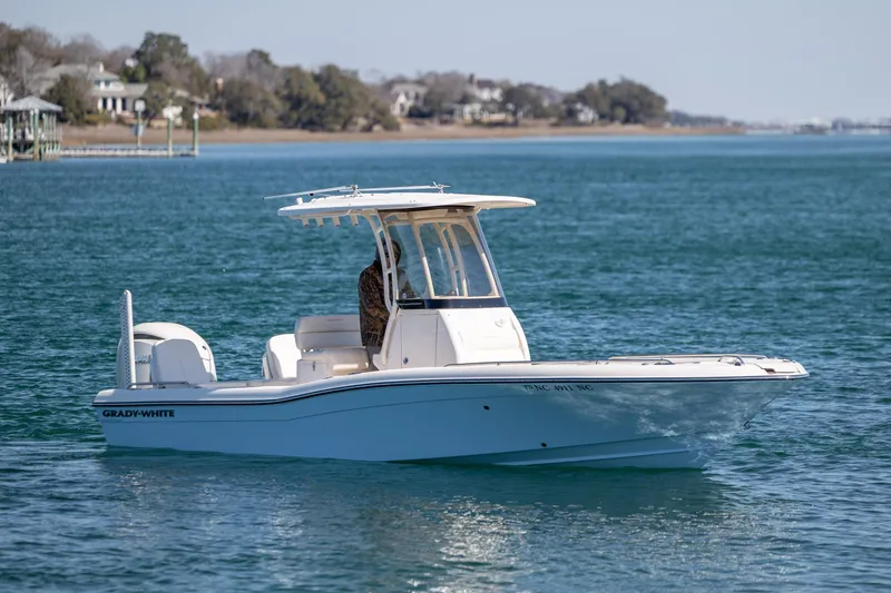 Slide: The Image of 2024 Grady-White 251 Coastal Explorer boat cruising on serene waters. - 2