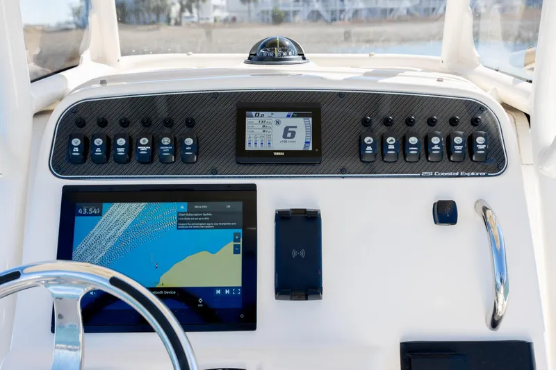 Slide: The Image of 2024 Grady-White 251 Coastal Explorer dashboard with navigation and control panels. - 24
