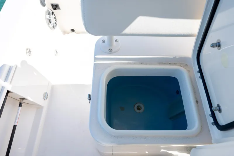 Slide: The Image of 2024 Grady-White 251 Coastal Explorer boat livewell, open lid, white interior. - 30