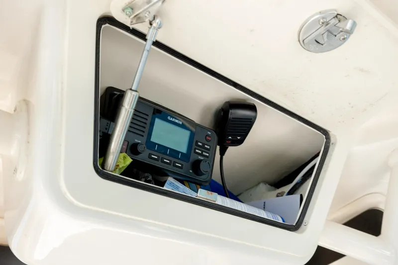 Slide: The Image of 2024 Grady-White 251 Coastal Explorer boat radio compartment with Garmin device. - 32