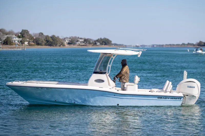 Slide: The Image of 2024 Grady-White 251 Coastal Explorer boat cruising on calm blue waters. - 6