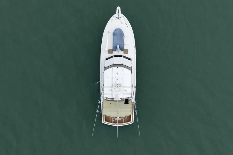 Slide: The Image of Aerial view of 1984 Hatteras 52 Convertible yacht on calm water. - 12