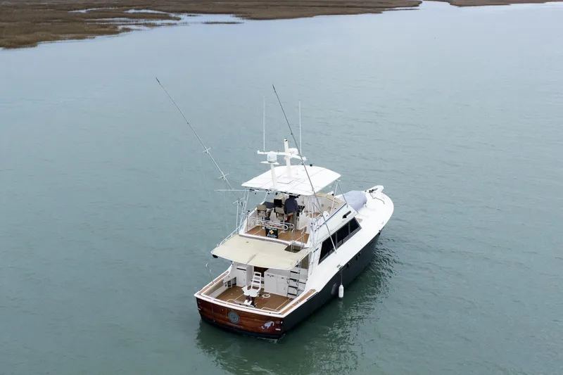 Slide: The Image of 1984 Hatteras 52 Convertible yacht on calm water, aerial view. - 14