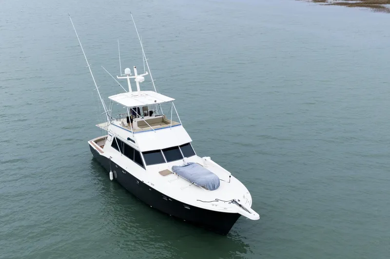 Slide: The Image of 1984 Hatteras 52 Convertible yacht on calm water, aerial view. - 15