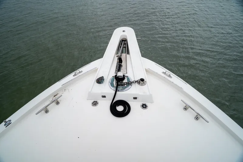 Slide: The Image of Bow of 1984 Hatteras 52 Convertible yacht on calm water. - 22