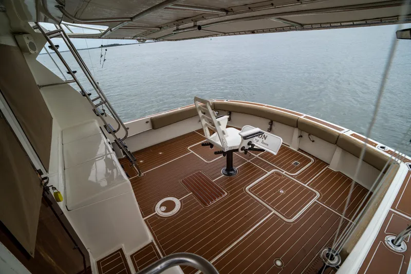 Slide: The Image of 1984 Hatteras 52 Convertible yacht deck with fishing chair and ocean view. - 27