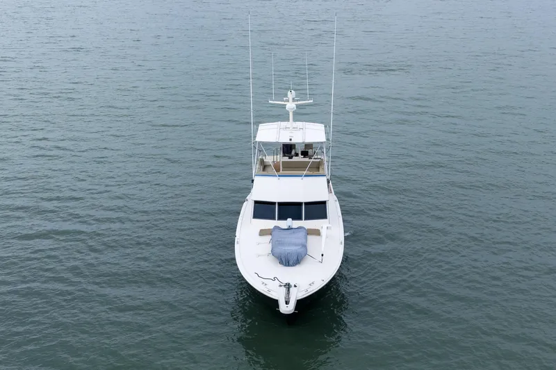 Slide: The Image of 1984 Hatteras 52 Convertible yacht on calm water, aerial view. - 3
