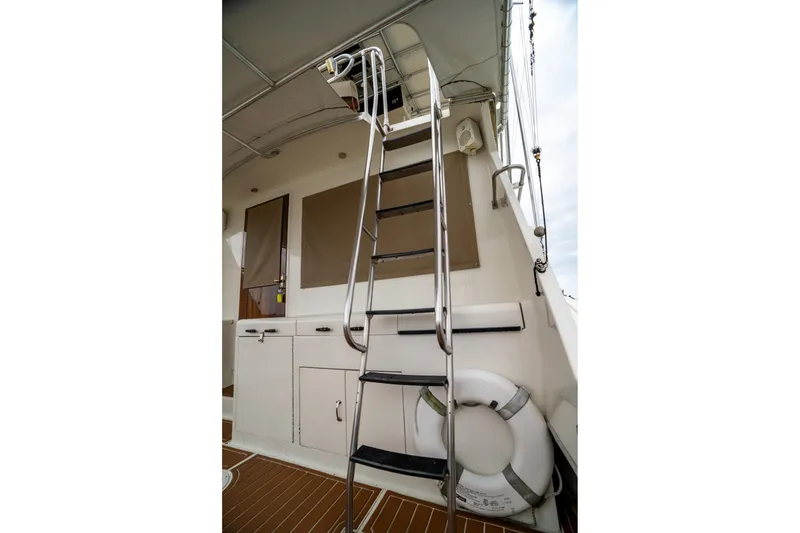 Slide: The Image of 1984 Hatteras 52 Convertible yacht ladder and deck area with life preserver. - 39