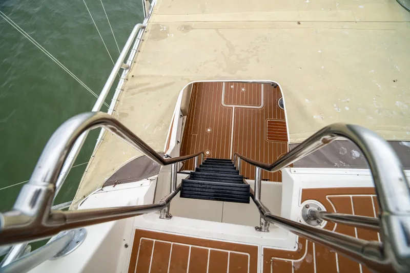Slide: The Image of Staircase on 1984 Hatteras 52 Convertible yacht with teak deck and stainless steel railings. - 41