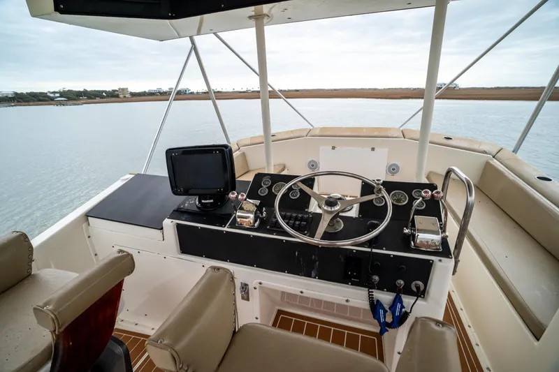 Slide: The Image of 1984 Hatteras 52 Convertible yacht helm with steering wheel and navigation equipment. - 45