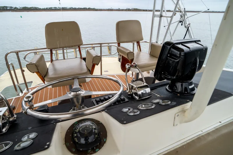 Slide: The Image of 1984 Hatteras 52 Convertible yacht helm with steering wheel and navigation equipment. - 46