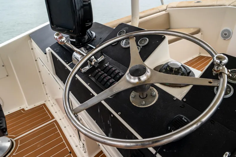 Slide: The Image of Helm of 1984 Hatteras 52 Convertible yacht with steering wheel and navigation instruments. - 48