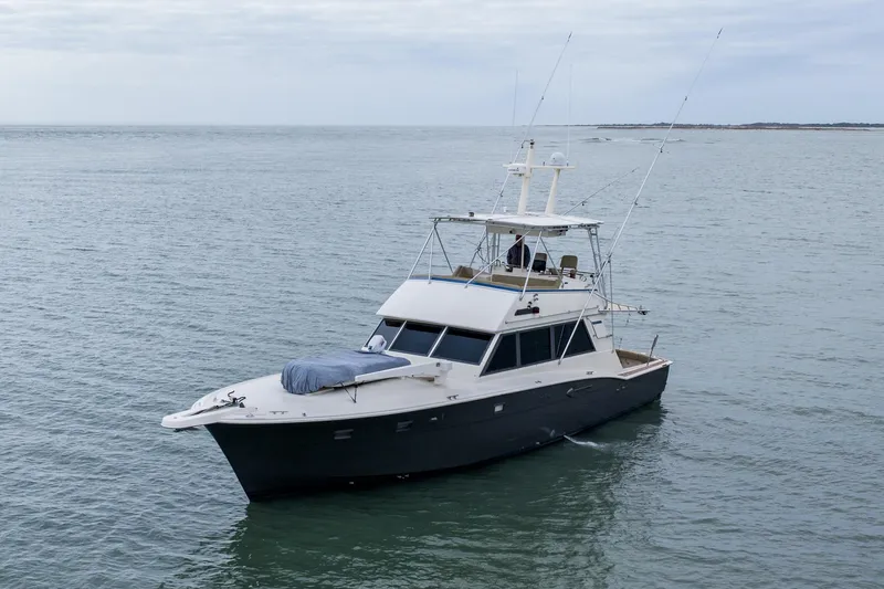 Slide: The Image of 1984 Hatteras 52 Convertible yacht cruising on calm ocean waters. - 5