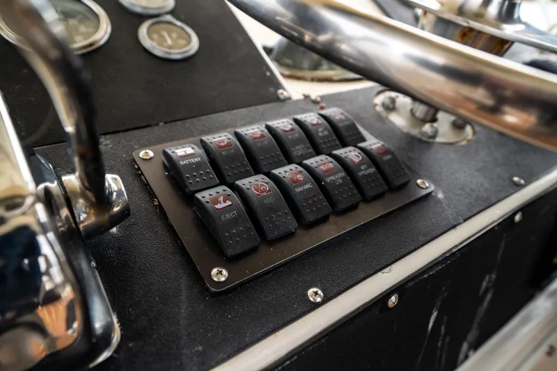 Slide: The Image of Control panel of 1984 Hatteras 52 Convertible yacht with labeled switches. - 51