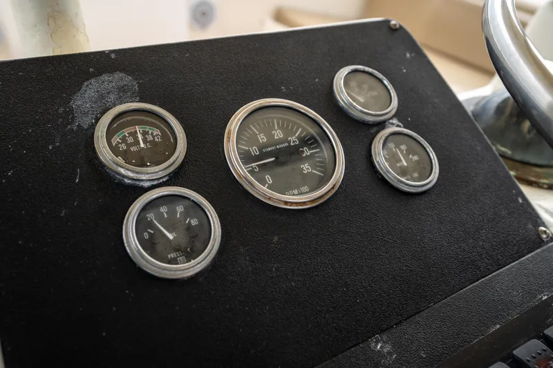 Slide: The Image of Dashboard gauges of a 1984 Hatteras 52 Convertible boat. - 52