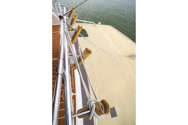 Slide: The Image of 1984 Hatteras 52 Convertible yacht deck with fishing rod holders. - 54