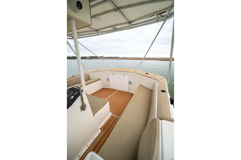Slide: The Image of 1984 Hatteras 52 Convertible boat deck with seating and water view. - 57