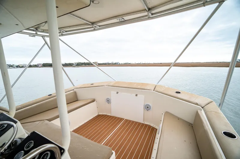 Slide: The Image of 1984 Hatteras 52 Convertible yacht interior with seating and water view. - 58