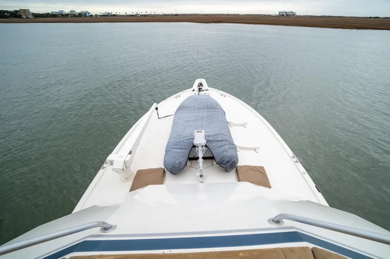 Slide: The Image of Bow view of 1984 Hatteras 52 Convertible yacht on calm water. - 59