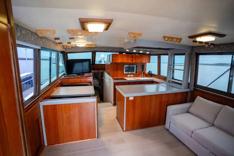Slide: The Image of Interior of 1984 Hatteras 52 Convertible yacht with modern kitchen and seating area. - 60