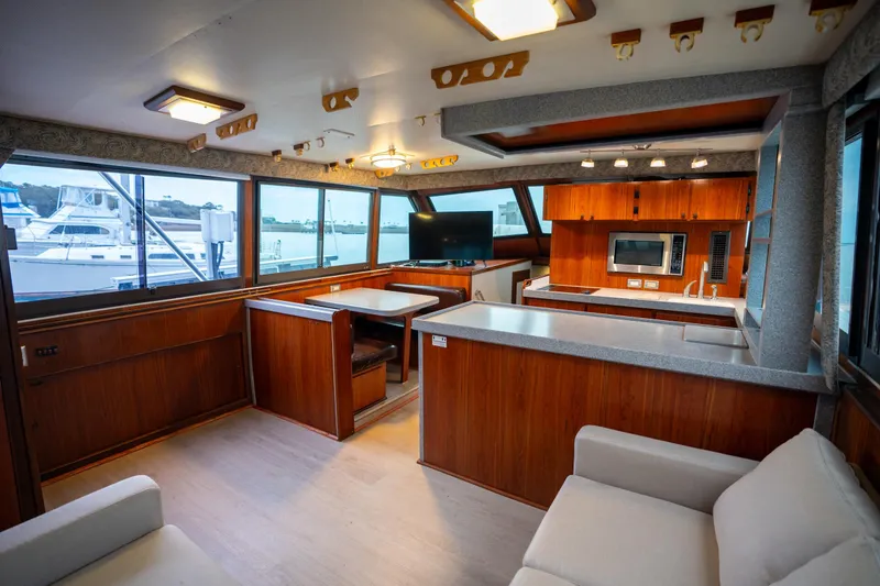 Slide: The Image of Interior of 1984 Hatteras 52 Convertible yacht with modern kitchen and seating area. - 61