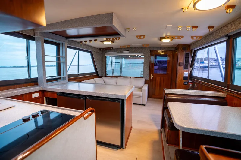 Slide: The Image of Interior of 1984 Hatteras 52 Convertible yacht with modern kitchen and seating area. - 62