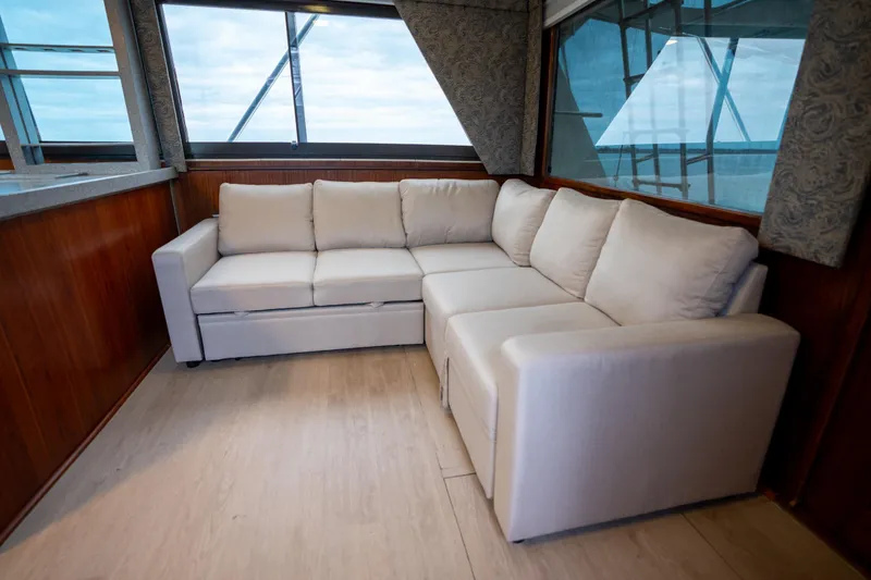 Slide: The Image of Luxurious interior of 1984 Hatteras 52 Convertible yacht with elegant white sectional sofa. - 65