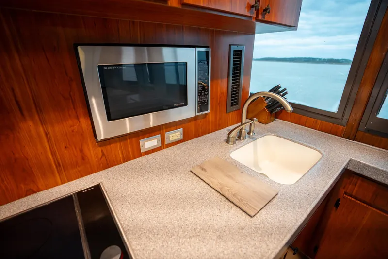 Slide: The Image of Kitchen area of 1984 Hatteras 52 Convertible yacht with sink and microwave. - 70