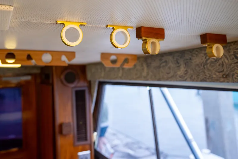 Slide: The Image of Interior of 1984 Hatteras 52 Convertible yacht with wooden and brass ceiling fixtures. - 74