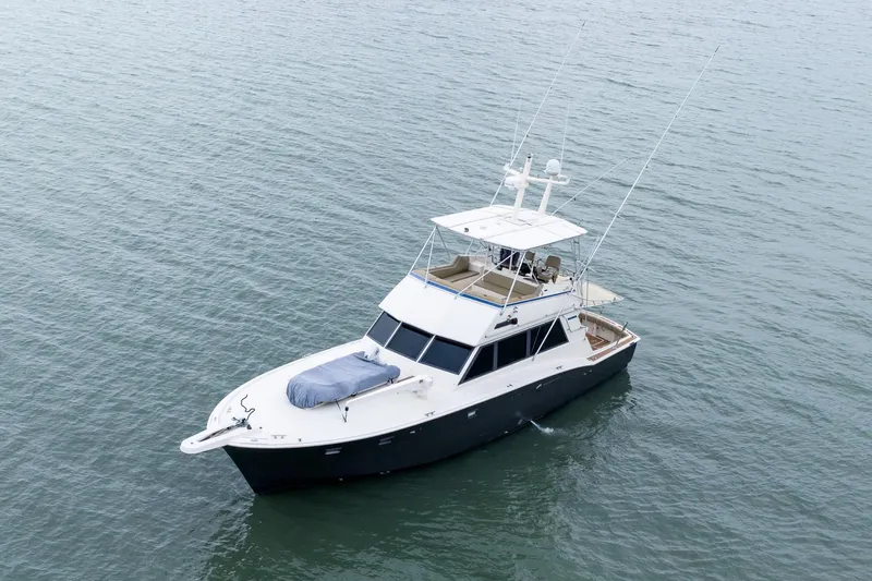 Slide: The Image of 1984 Hatteras 52 Convertible yacht on calm water, aerial view. - 8