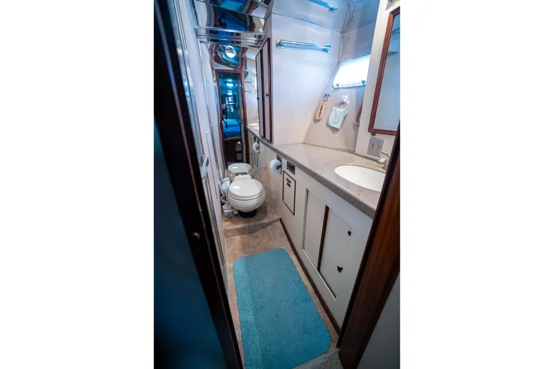 Slide: The Image of 1984 Hatteras 52 Convertible yacht bathroom with modern fixtures and blue accents. - 82