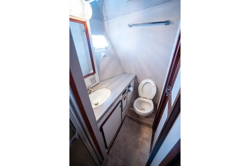 Slide: The Image of Bathroom interior of 1984 Hatteras 52 Convertible yacht, featuring sink and toilet. - 90
