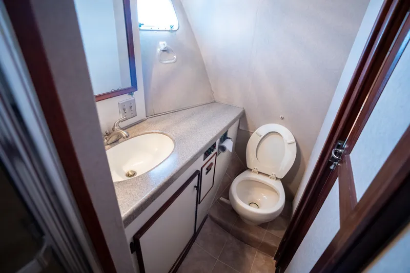 Slide: The Image of Bathroom interior of 1984 Hatteras 52 Convertible yacht, featuring sink and toilet. - 91