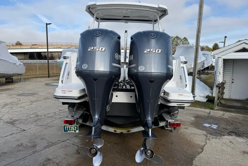 Slide: The Image of 2019 Blackfin 272 DC boat with dual Yamaha 250 outboard engines, parked outdoors. - 11