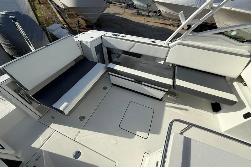 Slide: The Image of 2019 Blackfin 272 DC boat interior with white seating and storage compartments. - 16