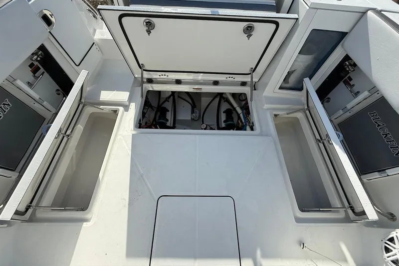 Slide: The Image of 2019 Blackfin 272 DC boat storage compartments open, showcasing interior space and design. - 19