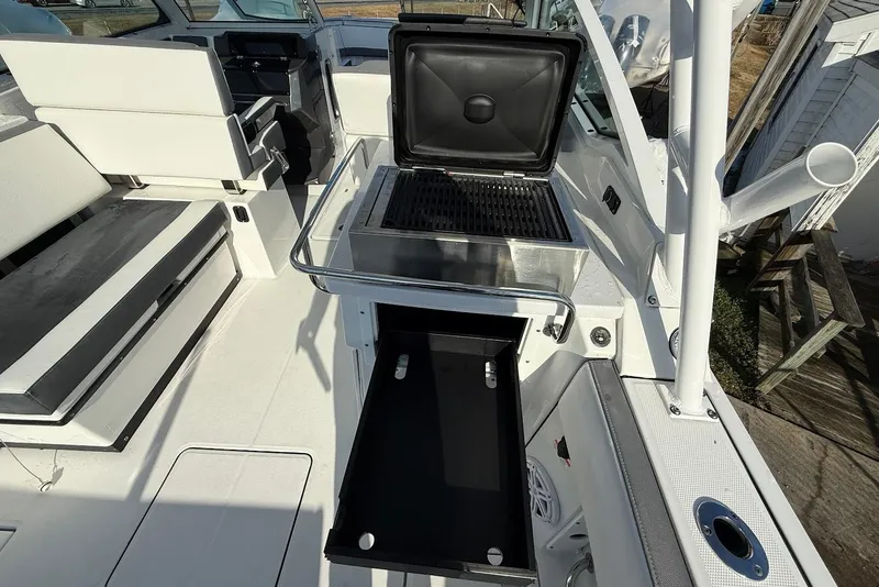 Slide: The Image of 2019 Blackfin 272 DC boat interior with grill and seating area. - 22
