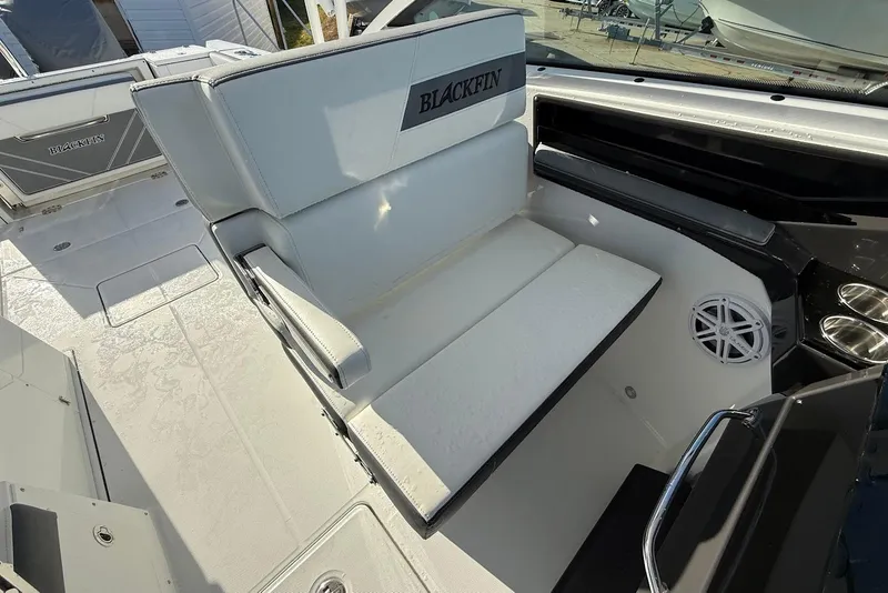 Slide: The Image of 2019 Blackfin 272 DC boat interior with white seating and speaker. - 27