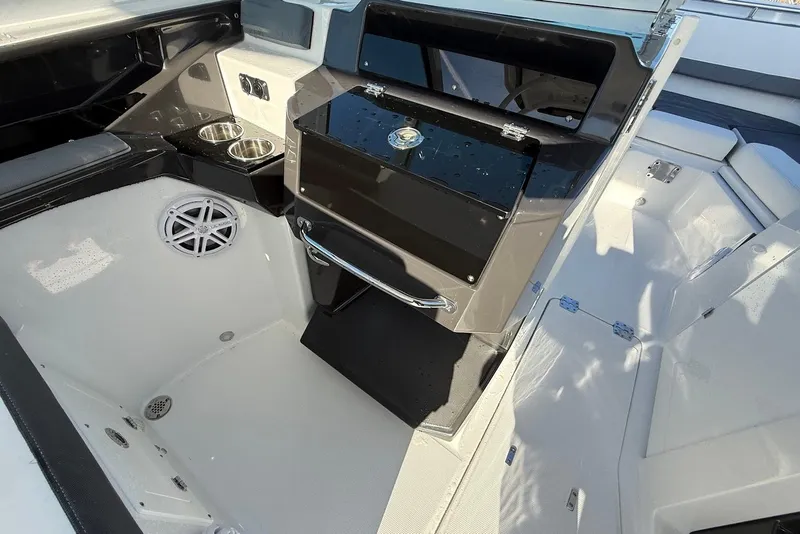 Slide: The Image of 2019 Blackfin 272 DC boat interior with storage, cup holders, and speaker. - 28