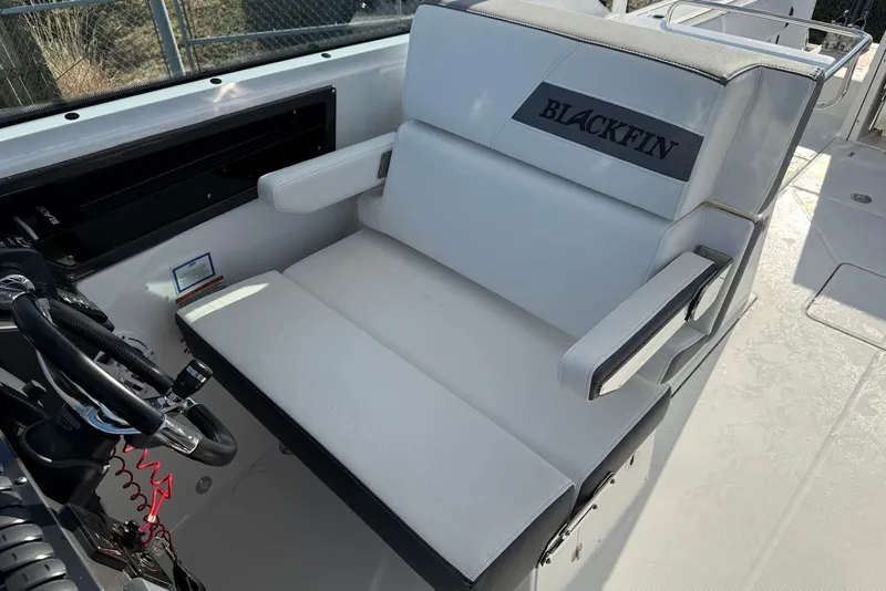 Slide: The Image of 2019 Blackfin 272 DC boat interior with steering wheel and cushioned seating. - 33