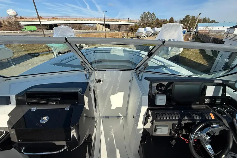 Slide: The Image of 2019 Blackfin 272 DC boat cockpit with modern controls and steering wheel. - 34