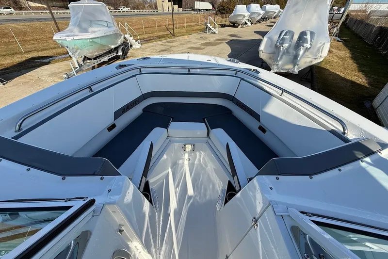 Slide: The Image of 2019 Blackfin 272 DC boat with spacious seating, docked outdoors. - 35