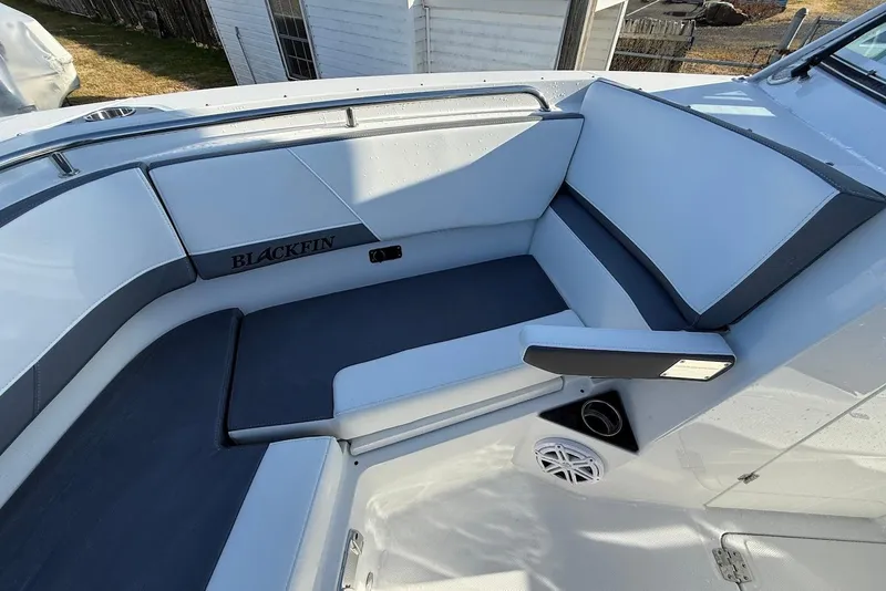 Slide: The Image of 2019 Blackfin 272 DC boat interior with cushioned seating and speaker. - 37