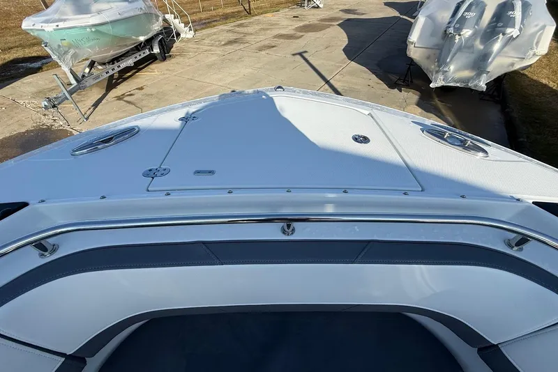 Slide: The Image of 2019 Blackfin 272 DC boat bow view, docked with other boats nearby. - 38