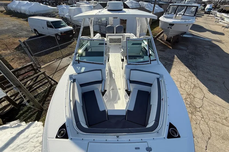 Slide: The Image of 2019 Blackfin 272 DC boat with spacious seating, docked in a marina. - 40