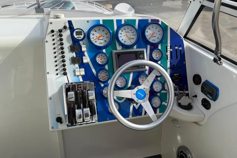 Slide: The Image of Dashboard of a 2010 Fountain 42 Lightning boat with gauges and controls. - 10