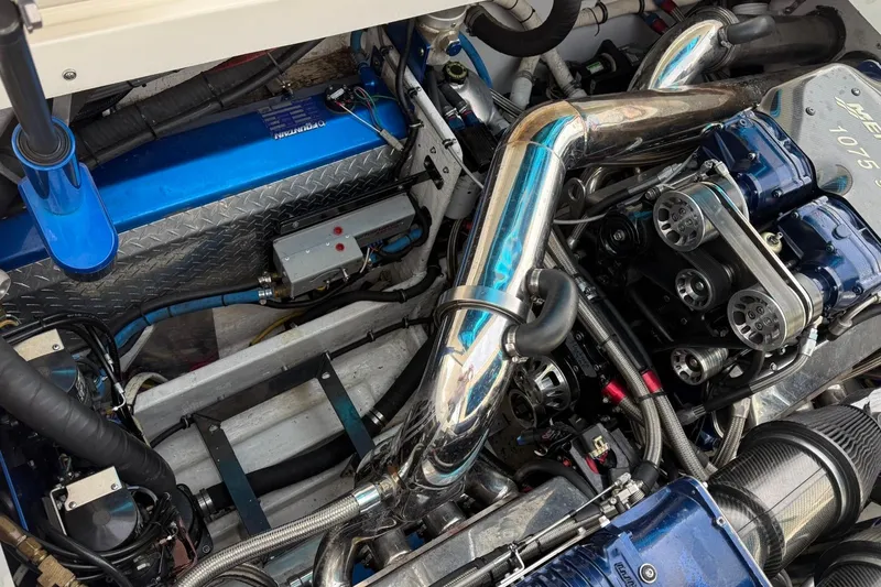 Slide: The Image of Engine compartment of a 2010 Fountain 42 Lightning boat, showcasing intricate mechanical components. - 12