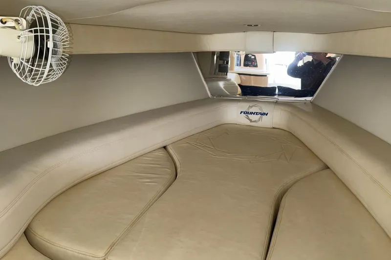 Slide: The Image of Interior cabin of 2010 Fountain 42 Lightning boat with beige seating and fan. - 16