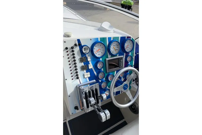 Slide: The Image of Control panel of 2010 Fountain 42 Lightning boat with gauges and steering wheel. - 18