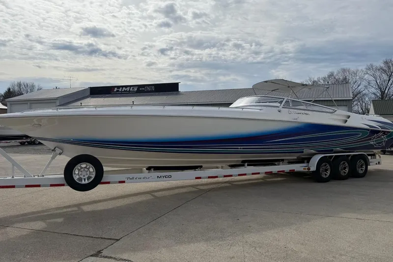 Slide: The Image of 2010 Fountain 42 Lightning speedboat on trailer, featuring sleek design and vibrant blue accents. - 2